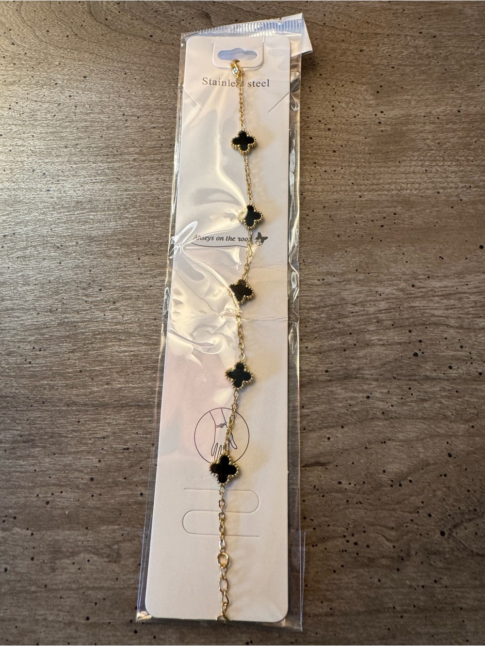 Gold Tone Chain Bracelet with Black Clover Accents